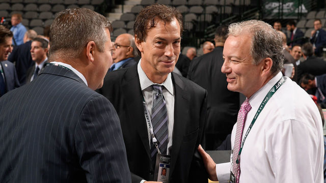 DALLAS, TX - JUNE 23: General manager Joe Sakic of the Colorado Avalanche (C) and general manager Ray Shero of the New Jersey Devils (R) talk on the draft floor during the 2018 NHL Draft at American Airlines Center on June 23, 2018 in Dallas, Texas.