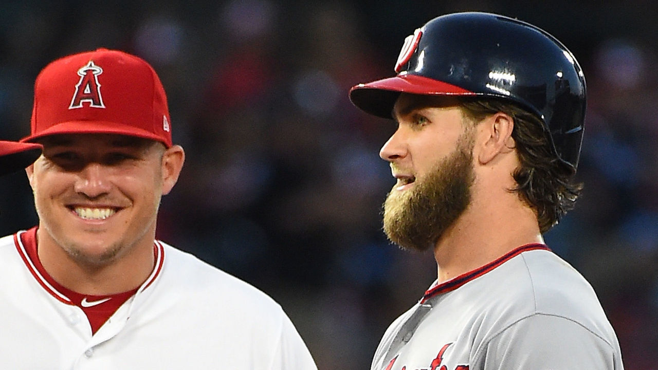 ANAHEIM, CA - JULY 18: Bryce Harper #34 of the Washington Nationals talks with Kole Calhoun #56 and Mike Trout #27 of the Los Angeles Angels as a play if being reviewed in the game at Angel Stadium of Anaheim on July 18, 2017 in Anaheim, California.