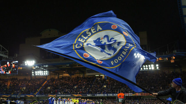 7th March 2019, Stamford Bridge, London, England; Europa League football, round of 16, 1st leg, Chelsea versus Dynamo Kiev; A flag bearer waves the Chelsea flag as the players line up ready for kick off