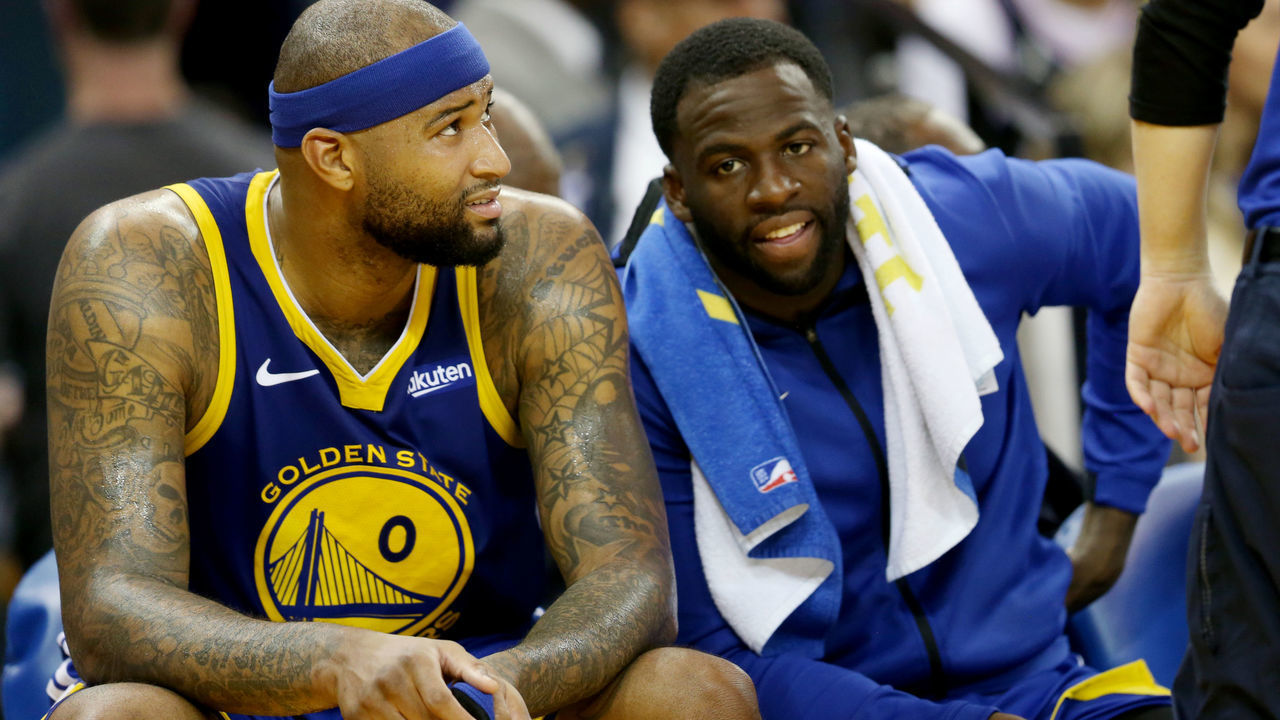 OAKLAND, CALIFORNIA - MARCH 5: Golden State Warriors' DeMarcus Cousins (0) and Draymond Green (23) talk each other on the bench during the fourth quarter of a NBA game against the Boston Celtics at Oracle Arena in Oakland, Calif., on Tuesday, March 5, 2019. Warriors lost 128-95. (Ray Chavez/MediaNews Group/The Mercury News via Getty Images)'n