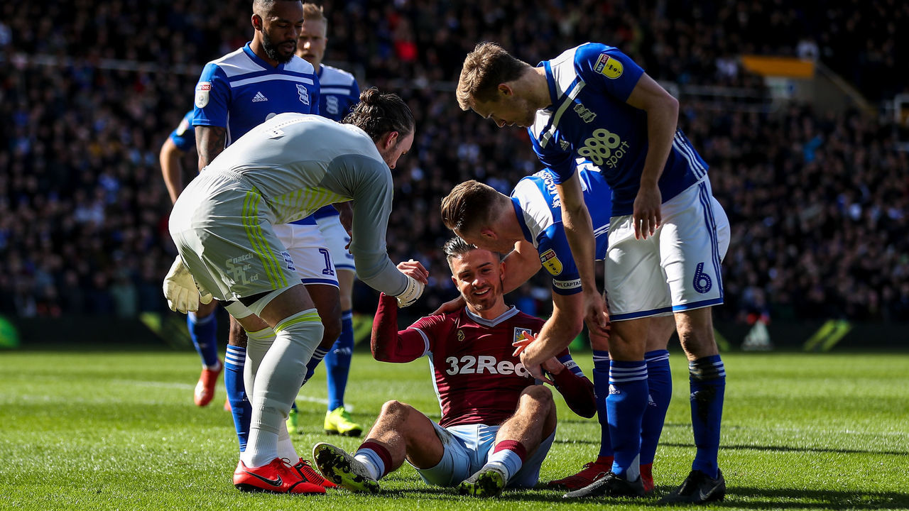 10th March 2019, St Andrew's Trillion Trophy Stadium, Birmingham, England; EFL Championship football, Birmingham City versus Aston Villa; Jack Grealish of Aston Villa is helped up after being knocked down by a fan who punched him in the jaw from behind