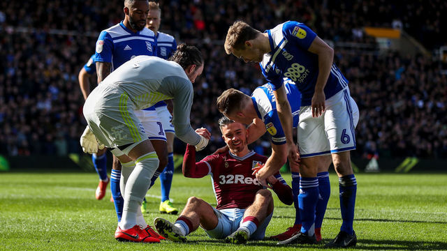 10th March 2019, St Andrew's Trillion Trophy Stadium, Birmingham, England; EFL Championship football, Birmingham City versus Aston Villa; Jack Grealish of Aston Villa is helped up after being knocked down by a fan who punched him in the jaw from behind