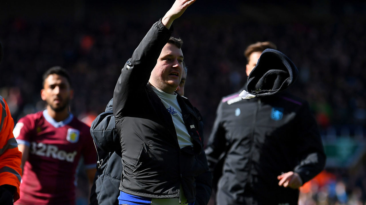 BIRMINGHAM, ENGLAND - MARCH 10: A fan is escorted off the pitch after striking Jack Grealish of Aston Villa during the Sky Bet Championship match between Birmingham City and Aston Villa at St Andrew's Trillion Trophy Stadium on March 10, 2019 in Birmingham, England.