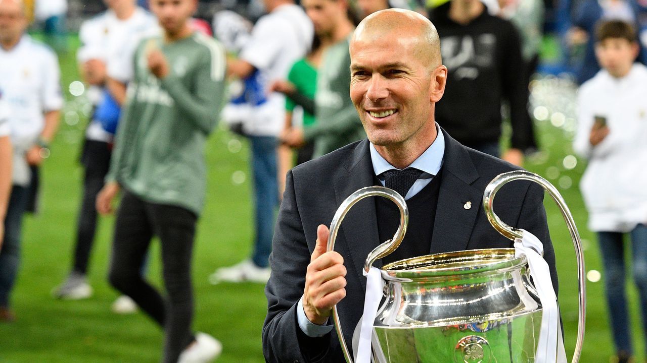 Real Madrid's French coach Zinedine Zidane poses with the trophy after winning the UEFA Champions League final football match between Liverpool and Real Madrid at the Olympic Stadium in Kiev, Ukraine, on May 26, 2018.