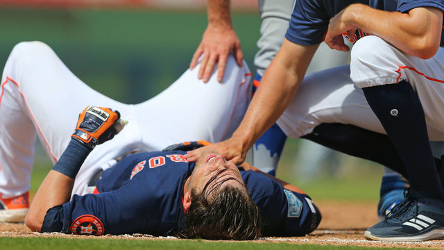 WEST PALM BEACH, FL - MARCH 11: Josh Reddick #22 of the Houston Astros is looked after by first base coach Don Kelly after grounding out and being tagged hard in the face by first baseman Pete Alonso #20 of the New York Mets during the fifth inning of a spring training baseball game at Fitteam Ballpark of the Palm Beaches on March 11, 2019 in West Palm Beach, Florida. The Astros defeated the Mets 6-3.