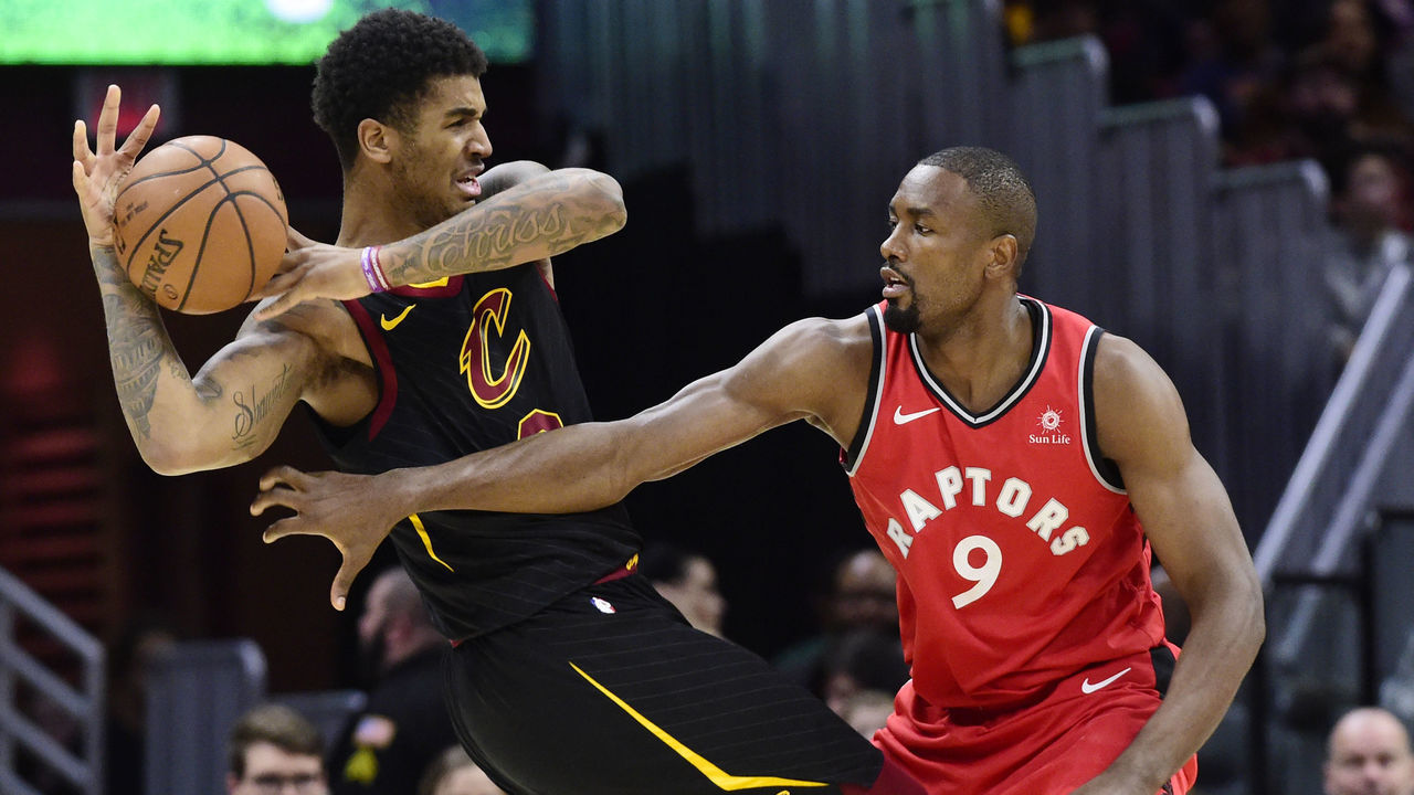 CLEVELAND, OHIO - MARCH 11: Marquese Chriss #3 of the Cleveland Cavaliers tries to keep control while under pressure from Serge Ibaka #9 of the Toronto Raptors during the first half at Quicken Loans Arena on March 11, 2019 in Cleveland, Ohio.