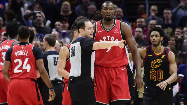 CLEVELAND, OHIO - MARCH 11: Referee Marat Kogut #32 directs Serge Ibaka #9 of the Toronto Raptors to the bench after he fought with Marquese Chriss #3 of the Cleveland Cavaliers during the second half at Quicken Loans Arena on March 11, 2019 in Cleveland, Ohio. The Cavaliers defeated the Raptors 126-101.