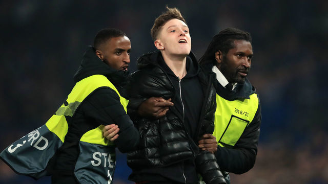 LONDON, ENGLAND - FEBRUARY 21: A fan is led away by stewards during the UEFA Europa League Round of 32 Second Leg match between Chelsea and Malmo FF at Stamford Bridge on February 21, 2019 in London, England.