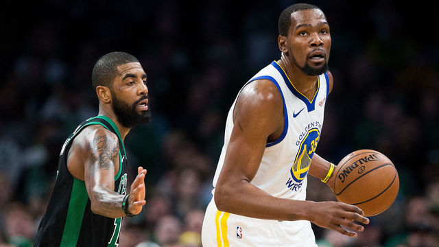 BOSTON, MA - JANUARY 26: Kyrie Irving #11 of the Boston Celtics guards Kevin Durant #35 of the Golden State Warriors during a game at TD Garden on January 26, 2019 in Boston, Massachusetts.
