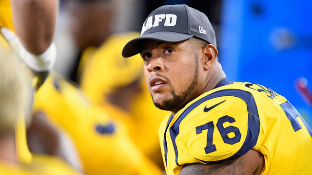 LOS ANGELES, CA - NOVEMBER 19: Rodger Saffold #76 of the Los Angeles Rams wears an LAFD hat in honor of the Los Angeles Fire Department battling the Woolsey fire before playing in the game against the Los Angeles Chargers at Los Angeles Memorial Coliseum on November 19, 2018 in Los Angeles, California.
