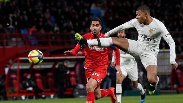 Dijon's New Caledonian defender Wesley Lautoa (L) vies with Paris Saint-Germain's French forward Kylian Mbappe during the French L1 football match between Dijon (DFCO) and Paris Saint-Germain (PSG), at the Gaston-Gerard stadium in Dijon on March 12, 2019.