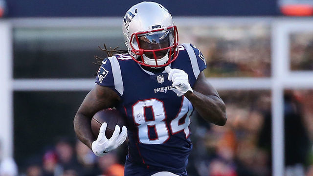 FOXBOROUGH, MA - DECEMBER 23: Cordarrelle Patterson #84 of the New England Patriots runs with the ball against Lorenzo Alexander #57 of the Buffalo Bills during the first half at Gillette Stadium on December 23, 2018 in Foxborough, Massachusetts.