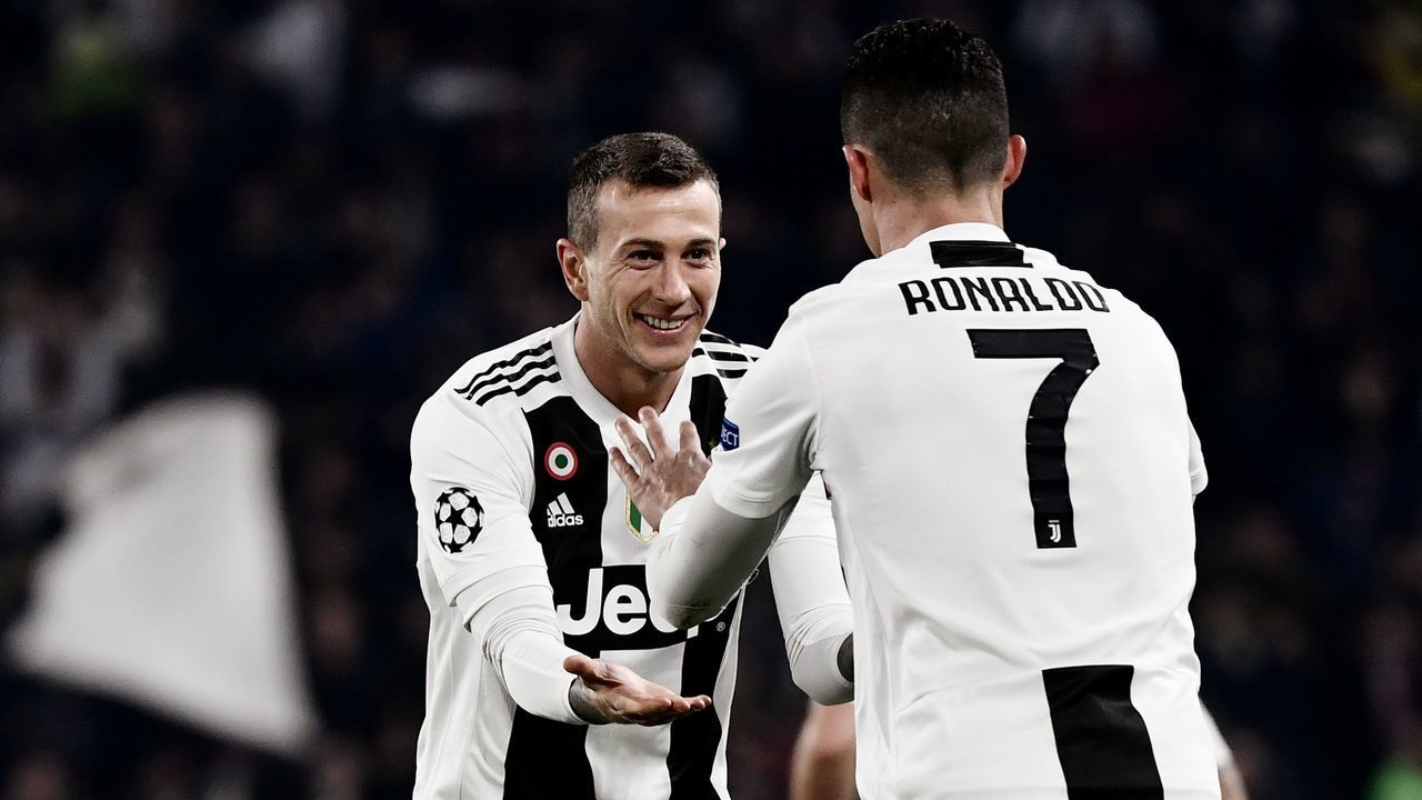 Juventus' Portuguese forward Cristiano Ronaldo (R) celebrates with Juventus' Italian forward Federico Bernardeschi after scoring 2-0 during the UEFA Champions League round of 16 second-leg football match Juventus vs Atletico Madrid on March 12, 2019 at the Juventus stadium in Turin.