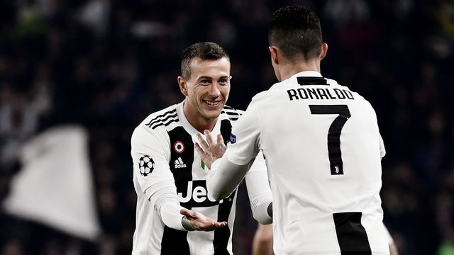 Juventus' Portuguese forward Cristiano Ronaldo (R) celebrates with Juventus' Italian forward Federico Bernardeschi after scoring 2-0 during the UEFA Champions League round of 16 second-leg football match Juventus vs Atletico Madrid on March 12, 2019 at the Juventus stadium in Turin.