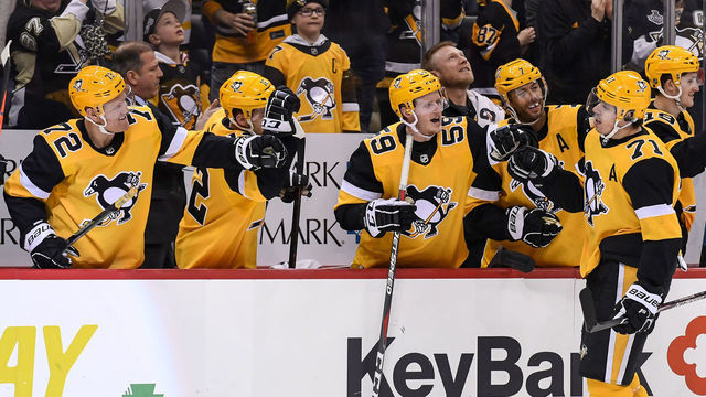 PITTSBURGH, PA - MARCH 12: Pittsburgh Penguins Center Evgeni Malkin (71) celebrates his 1,000 NHL career point with teammates on the bench during the third period in the NHL game between the Pittsburgh Penguins and the Washington Capitals on March 12, 2019, at PPG Paints Arena in Pittsburgh, PA.