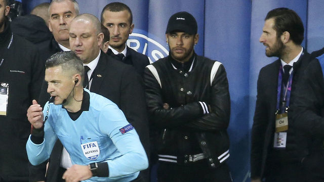 PARIS, FRANCE - MARCH 6: Referee Damir Skomina of Slovenia uses the VAR (video assistance) in front of Neymar Jr of PSG on the sideline (right), validating a penalty for Manchester United at the last minute of the match during the UEFA Champions League Round of 16 Second Leg match between Paris Saint-Germain (PSG) and Manchester United at Parc des Princes stadium on March 6, 2019 in Paris, France.