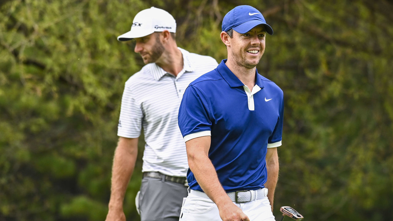 MEXICO CITY, MEX - FEBRUARY 23: Rory McIlroy of Northern Ireland smiles as he walks past Dustin Johnson on the 11th hole green during the third round of the World Golf Championships - Mexico Championship at Club de Golf Chapultepec on February 23, 2019 in Mexico City, Mexico.