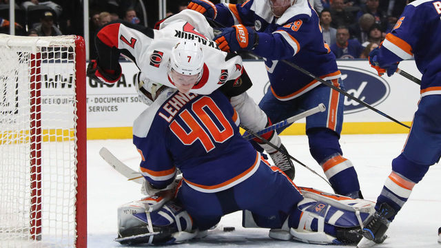 UNIONDALE, NEW YORK - MARCH 05: Brady Tkachuk #7 of the Ottawa Senators is checked over Robin Lehner #40 of the New York Islanders as the Senators tie the score at 4-4 in the third period at NYCB Live's Nassau Coliseum on March 05, 2019 in Uniondale, New York. The Islanders defeated the Senators 5-4 in the shoot-out.