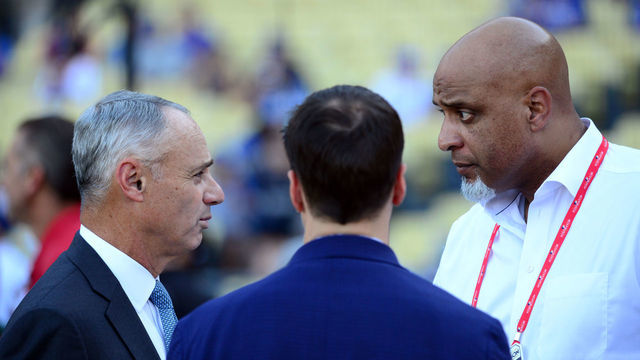 LOS ANGELES, CA - OCTOBER 25: Major League Baseball Commissioner Robert D. Manfred Jr. talks with Executive Director of the Major League Baseball Players Association Tony Clark during batting practice prior to Game 2 of the 2017 World Series between the Houston Astros and the Los Angeles Dodgers at Dodger Stadium on Wednesday, October 25, 2017 in Los Angeles, California.