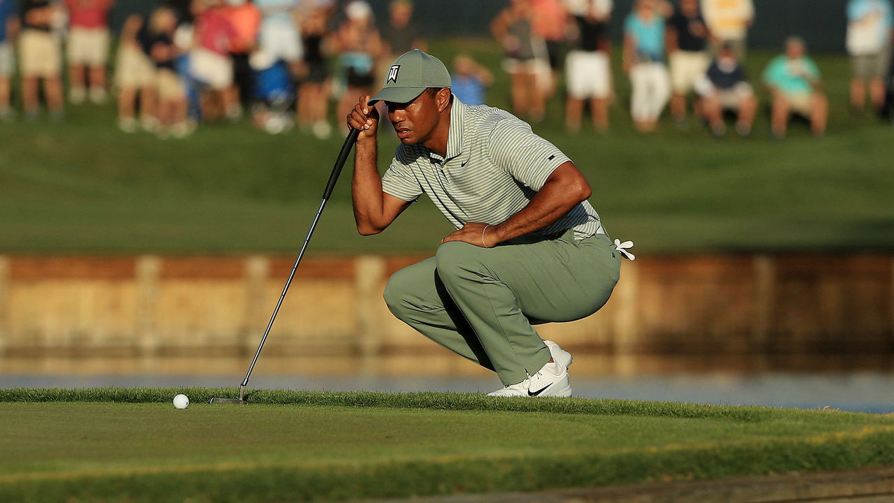 PONTE VEDRA BEACH, FLORIDA - MARCH 14: Tiger Woods of the United States lines up a putt on the 17th green during the first round of The PLAYERS Championship on The Stadium Course at TPC Sawgrass on March 14, 2019 in Ponte Vedra Beach, Florida.