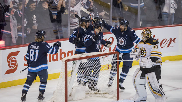 WINNIPEG, MB - MARCH 14: The Winnipeg Jets celebrate Mark Scheifele #55 goal against Tuukka Rak #40 of the Boston Bruins during 1st period action on March 14, 2019 at Bell MTS Place in Winnipeg, Manitoba, Canada.