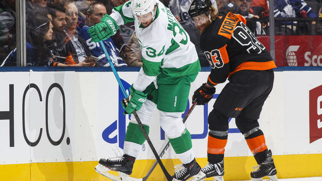 TORONTO, ON - MARCH 15: Auston Matthews #34 of the Toronto Maple Leafs plays the puck against Jakub Voracek #93 of the Philadelphia Flyers during the first period at the Scotiabank Arena on March 15, 2019 in Toronto, Ontario, Canada. The Toronto Maple Leafs are wearing their alternate St. Pats jerseys.