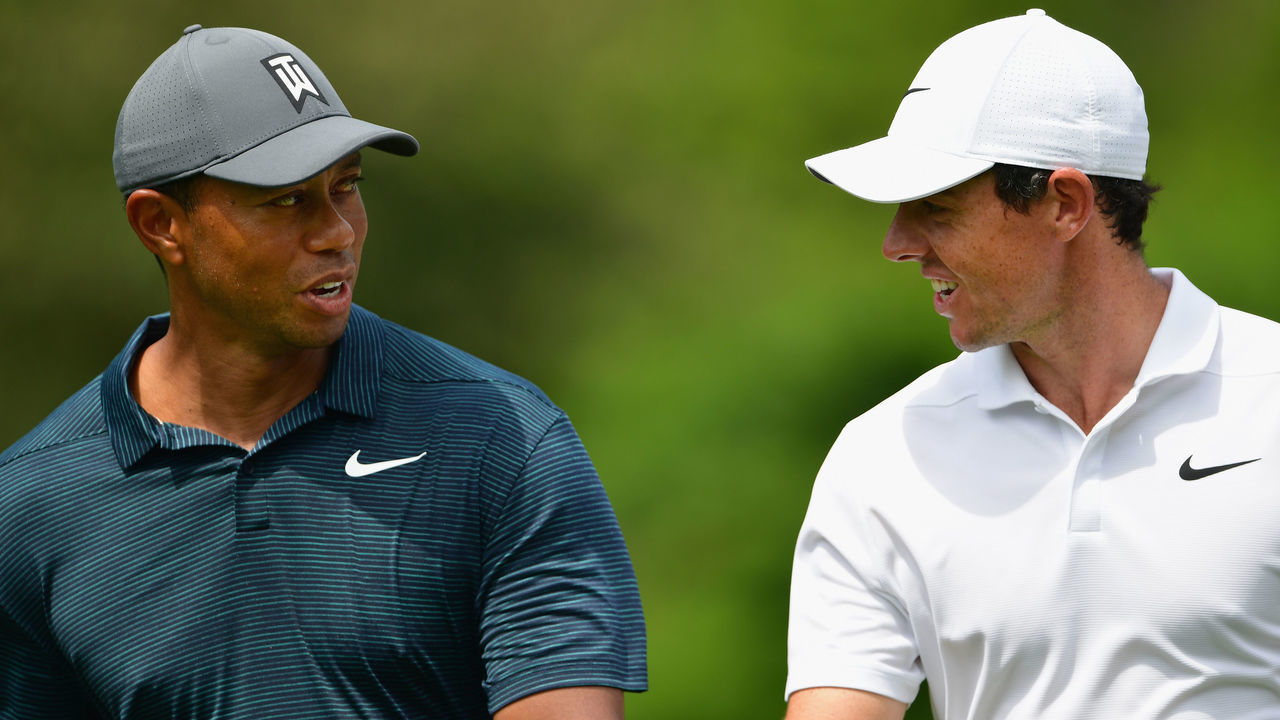 ST LOUIS, MO - AUGUST 09: Tiger Woods of the United States walks with Rory McIlroy of Northern Ireland during the first round of the 2018 PGA Championship at Bellerive Country Club on August 9, 2018 in St Louis, Missouri.