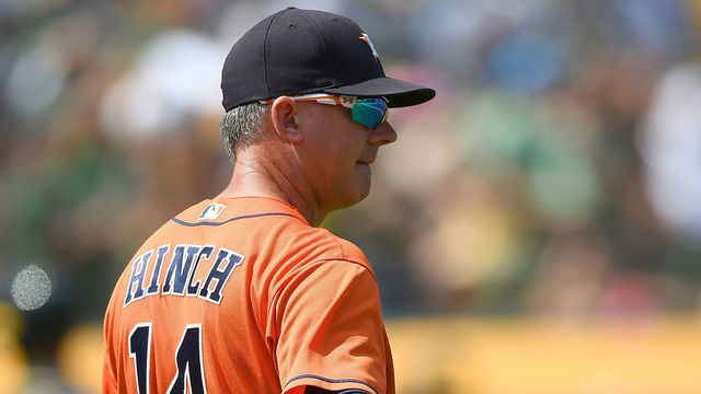 OAKLAND, CA - AUGUST 18: Manager AJ Hinch #14 of the Houston Astros signals the bullpen to make a pitching change against the Oakland Athletics in the bottom of the six inning at Oakland Alameda Coliseum on August 18, 2018 in Oakland, California.