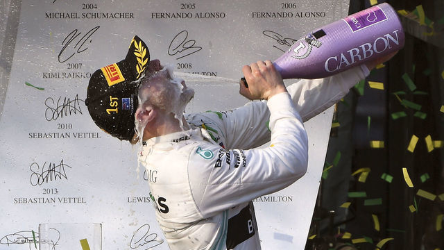 Mercedes' Finnish driver Valtteri Bottas celebrates on the podium after winning the Formula One Australian Grand Prix in Melbourne on March 17, 2019.