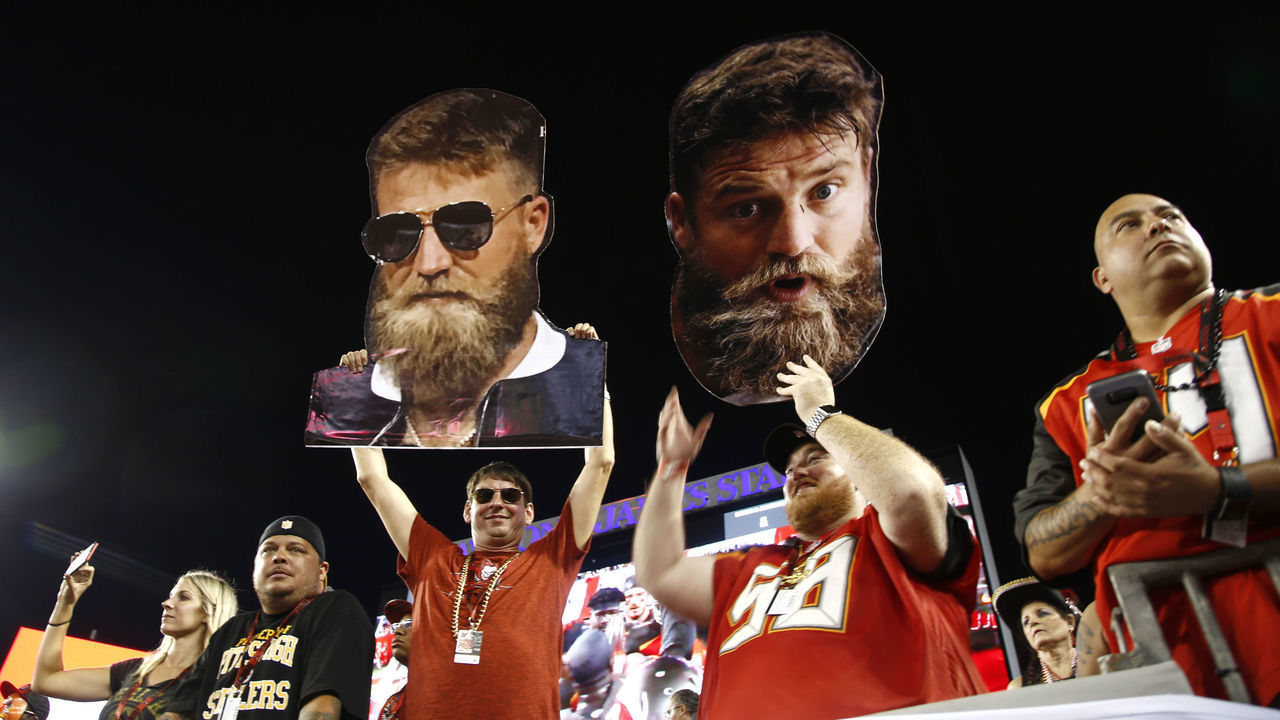 TAMPA, FL - SEPTEMBER 24: Football fans hold up large heads of quarterback Ryan Fitzpatrick #14 of the Tampa Bay Buccaneers before the start of a game against the Pittsburgh Steelers on September 24, 2018 at Raymond James Stadium in Tampa, Florida.