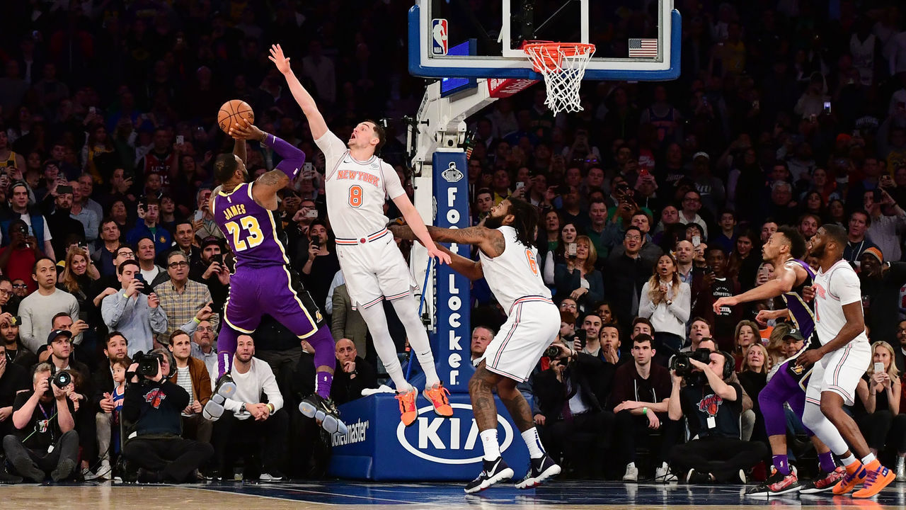 NEW YORK, NEW YORK - MARCH 17: LeBron James #23 of the Los Angeles Lakers attempts a basket but is blocked by Mario Hezonja #8 of the New York Knicks in the last seconds of the game at Madison Square Garden on March 17, 2019 in New York City. The New York Knicks defeat the Los Angeles Lakers 124-123.