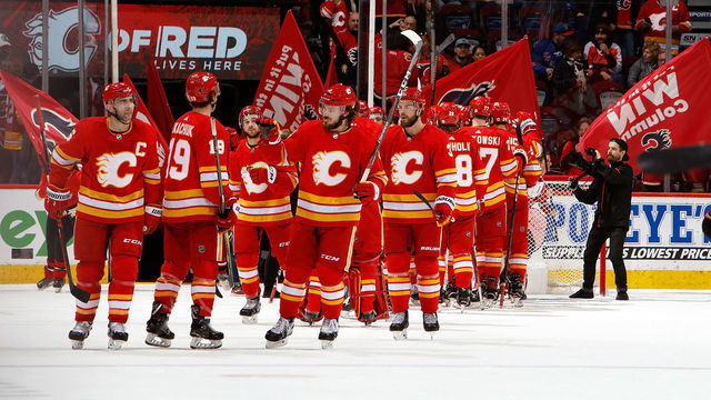CALGARY, AB - MARCH 15: Teammates of the Calgary Flames celebrate a win against the New York Rangers during an NHL game on March 15, 2019 at the Scotiabank Saddledome in Calgary, Alberta, Canada.