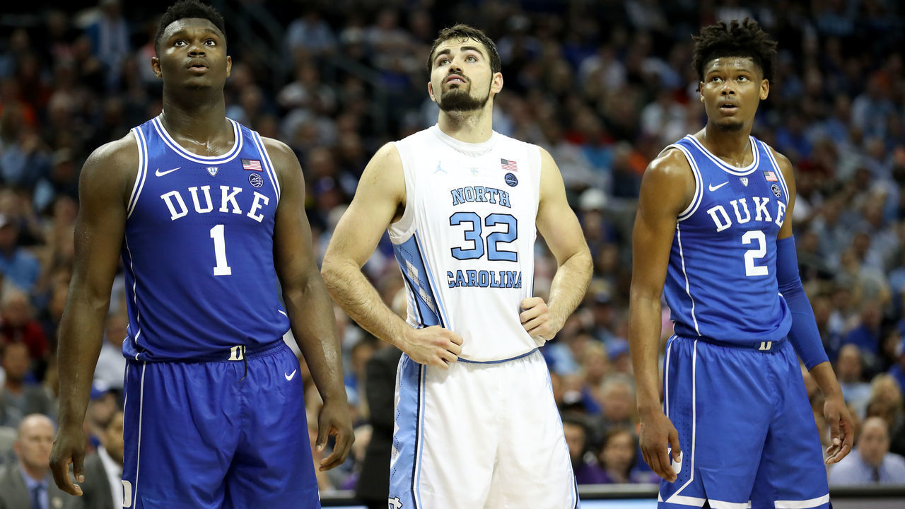 CHARLOTTE, NORTH CAROLINA - MARCH 15: Teammates Zion Williamson #1 and Cam Reddish #2 of the Duke Blue Devils await a free throw with Luke Maye #32 of the North Carolina Tar Heels during their game in the semifinals of the 2019 Men's ACC Basketball Tournament at Spectrum Center on March 15, 2019 in Charlotte, North Carolina.