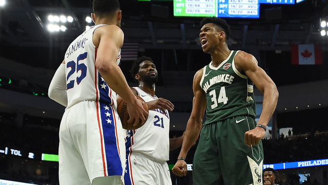 MILWAUKEE, WISCONSIN - MARCH 17: Giannis Antetokounmpo #34 of the Milwaukee Bucks reacts to a dunk over Ben Simmons #25 of the Philadelphia 76ers during the second half of a game at Fiserv Forum on March 17, 2019 in Milwaukee, Wisconsin.