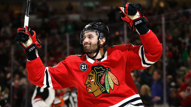 CHICAGO, ILLINOIS - MARCH 11: Brendan Perlini #11 of the Chicago Blackhawks celebrates his second goal of the game against the Arizona Coyotes at the United Center on March 11, 2019 in Chicago, Illinois.