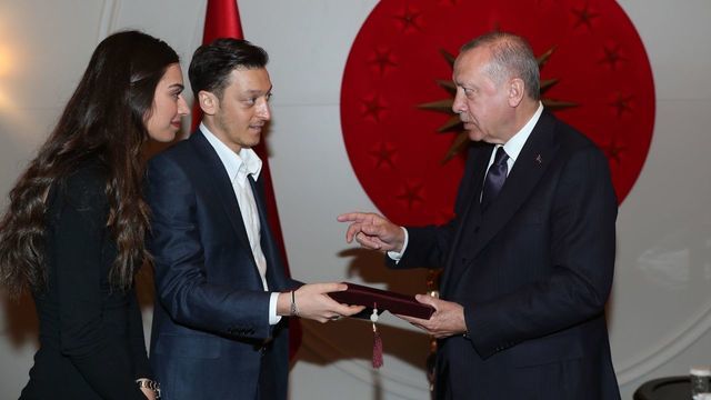 ISTANBUL, TURKEY - MARCH 15: (----EDITORIAL USE ONLY MANDATORY CREDIT - 'TURKISH PRESIDENCY / KAYHAN OZER / HANDOUT' - NO MARKETING NO ADVERTISING CAMPAIGNS - DISTRIBUTED AS A SERVICE TO CLIENTS----) Turkish-German footballer Mesut Ozil (C) and his fiancee Amine Gulse (L) present their wedding invitation to President of Turkey Recep Tayyip Erdogan (R), as Erdogan receives them at Ataturk Airport in Istanbul, Turkey on March 15, 2019.