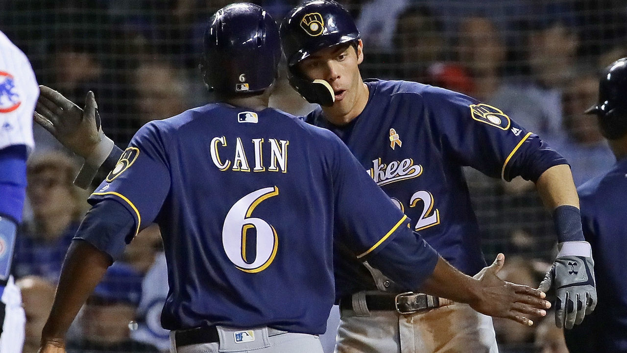 CHICAGO, IL - SEPTEMBER 12: Christian Yelich #22 and Lorenzo Cain #6 of the Milwaukee Brewers celebrate after scoring runs in the 9th inning against the Chicago Cubs at Wrigley Field on September 12, 2018 in Chicago, Illinois. The Brewers defeated the Cubs 5-1.