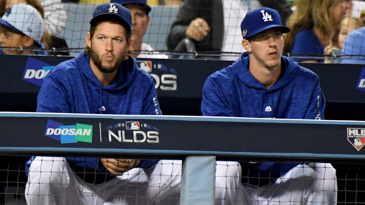 LOS ANGELES, CA- OCTOBER 5: Clayton Kershaw, left, along with Walker Buehler #21 of the Los Angeles Dodgers look on in the fourth inning of game one of the National League Division Series against the Atlanta Braves] at Dodger Stadium on Thursday, October 4, 2018 in Los Angeles, California.