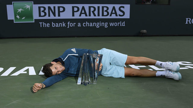 INDIAN WELLS, CA - MARCH 17: Dominic Thiem of Austria holds the championship trophy after his men's singles final victory against Roger Federer of Switzerland on day fourteen of the BNP Paribas Open at the Indian Wells Tennis Gardenon March 17, 2019 in Indian Wells, California.