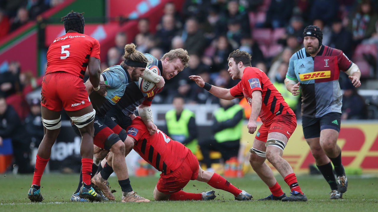 LONDON, ENGLAND - JANUARY 26: Renaldo Bothma of Harlequins is tackled by the Saracens defence during the Premiership Rugby Cup match between Harlequins and Saracens at Twickenham Stoop on January 26, 2019 in London, United Kingdom.