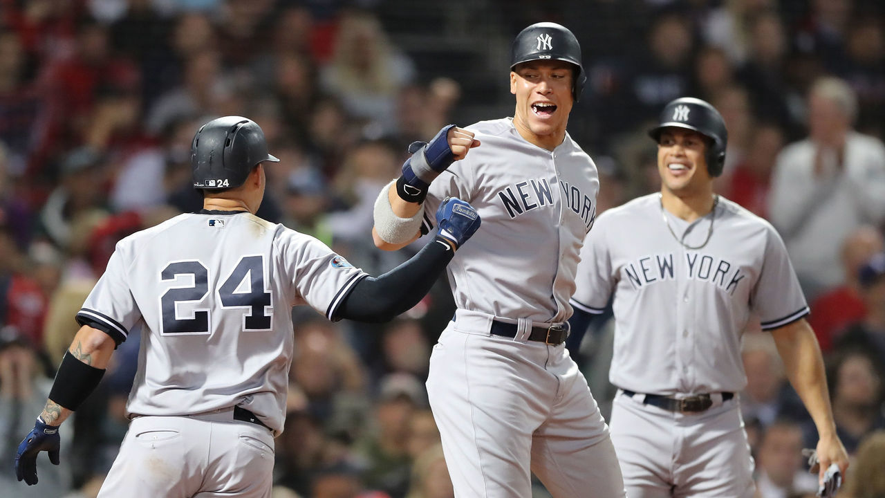 BOSTON, MA - OCTOBER 06: Gary Sanchez #24 and Aaron Judge #99 of the New York Yankees celebrate after Sanchez hit a three-run home run as teammate Giancarlo Stanton #27 watches during the seventh inning of Game Two of the American League Division Series against the Boston Red Sox at Fenway Park on October 6, 2018 in Boston, Massachusetts.