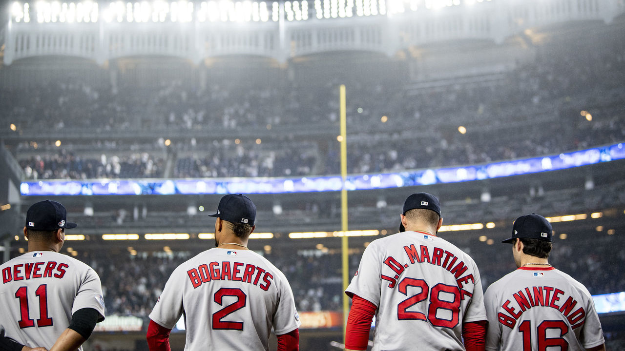 NEW YORK, NY - OCTOBER 8: Rafael Devers #11, Xander Bogaerts #2, J.D. Martinez #28, and Andrew Benintendi #16 of the Boston Red Sox look on before game three of the American League Division Series against the New York Yankees on October 8, 2018 at Yankee Stadium in the Bronx borough of New York City.