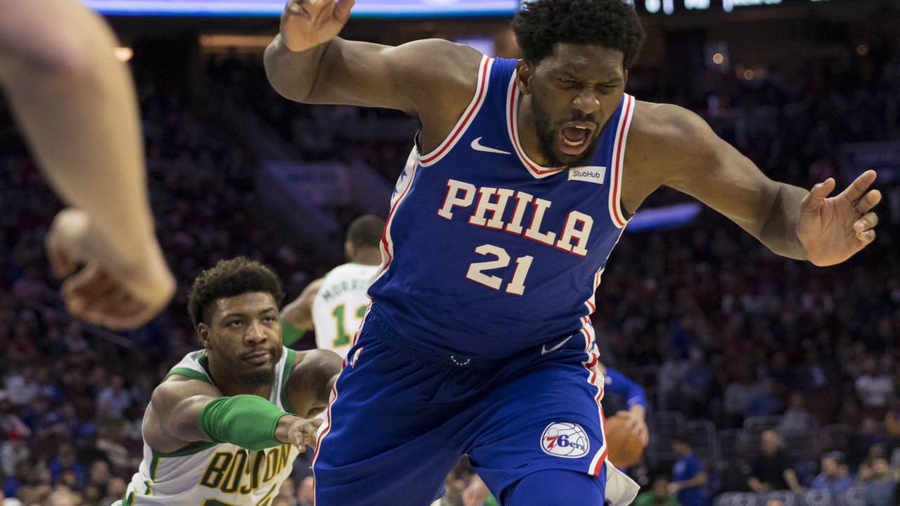 PHILADELPHIA, PA - MARCH 20: Marcus Smart #36 of the Boston Celtics pushes Joel Embiid #21 of the Philadelphia 76ers to the ground in the third quarter at the Wells Fargo Center on March 20, 2019 in Philadelphia, Pennsylvania. The 76ers defeated the Celtics 118-115.