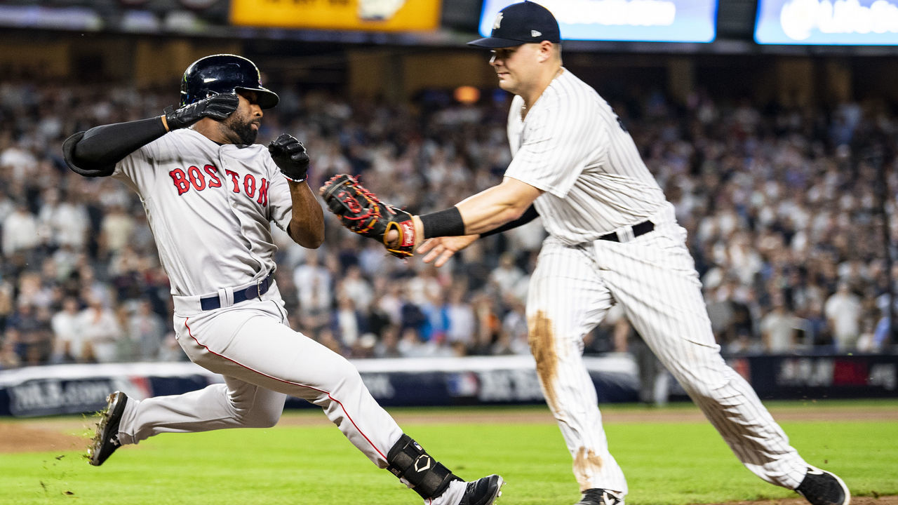 NEW YORK, NY - OCTOBER 9: Jackie Bradley Jr. #19 of the Boston Red Sox slides as he is tagged out by Luke Voit #45 of the New York Yankees during the third inning of game four of the American League Division Series on October 9, 2018 at Yankee Stadium in the Bronx borough of New York City.