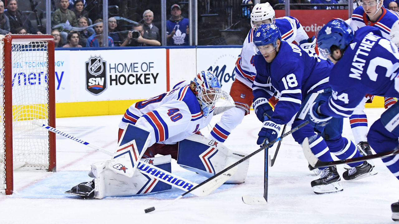 TORONTO, ON - MARCH 23: Toronto Maple Leafs Left Wing Andreas Johnsson (18) and Center Auston Matthews (34) are defended by New York Rangers Goalie Alexandar Georgiev (40) during the regular season NHL game between the New York Rangers and Toronto Maple Leafs on March 23, 2019 at Scotiabank Arena in Toronto, ON.