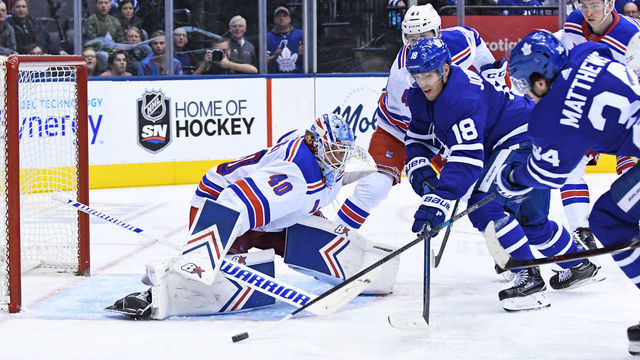 TORONTO, ON - MARCH 23: Toronto Maple Leafs Left Wing Andreas Johnsson (18) and Center Auston Matthews (34) are defended by New York Rangers Goalie Alexandar Georgiev (40) during the regular season NHL game between the New York Rangers and Toronto Maple Leafs on March 23, 2019 at Scotiabank Arena in Toronto, ON.