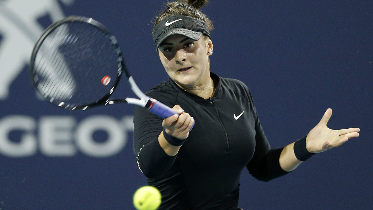 MIAMI GARDENS, FLORIDA - MARCH 23: Bianca Andreescu of Canada returns a shot to Angelique Kerber of Germany during Day 6 of the Miami Open Presented by Itau at Hard Rock Stadium on March 23, 2019 in Miami Gardens, Florida.