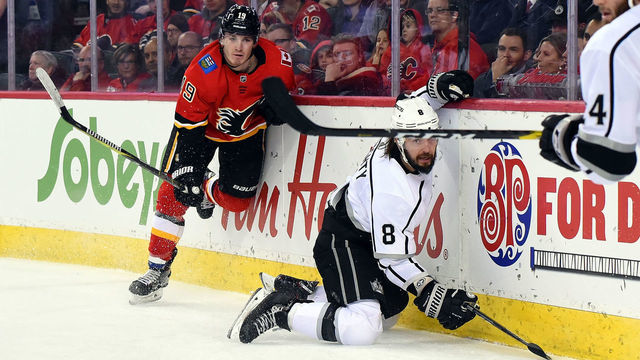 CALGARY, AB - NOVEMBER 30: Los Angeles Kings Defenceman Drew Doughty (8) is checked by Calgary Flames Left Wing Matthew Tkachuk (19) during the first period of an NHL game where the Calgary Flames hosted the Los Angeles Kings on November 30, 2018, at the Scotiabank Saddledome in Calgary, AB.