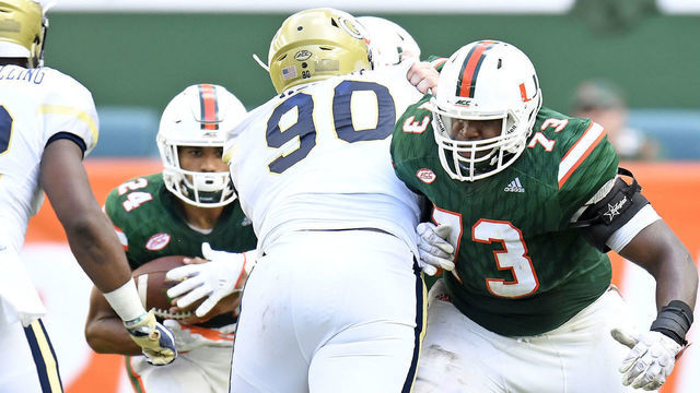 MIAMI GARDENS, FL - OCTOBER 14: University of Miami offensive lineman Trevor Darling (73) blocks Georgia Tech defensive lineman Brandon Adams (90) during an NCAA football game between the Georgia Tech Yellow Jackets and the University of Miami Hurricanes on October 14, 2017 at Hard Rock Stadium, Miami Gardens, Florida. Miami defeated Georgia Tech 25-24.