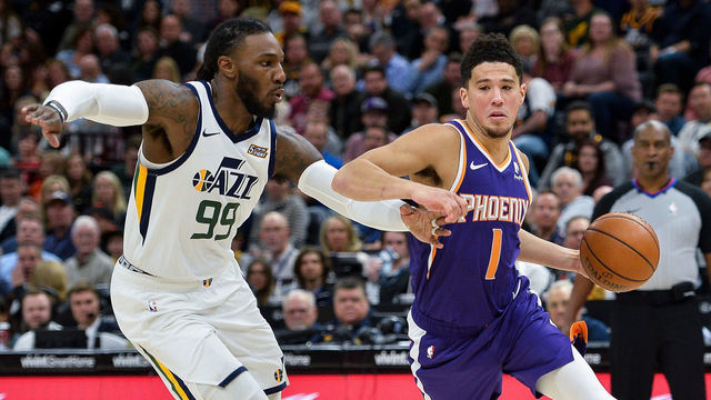 SALT LAKE CITY, UT - MARCH 25: Devin Booker #1 of the Phoenix Suns drives past Jae Crowder #99 of the Utah Jazz during a game at Vivint Smart Home Arena on March 25, 2019 in Salt Lake City, Utah.